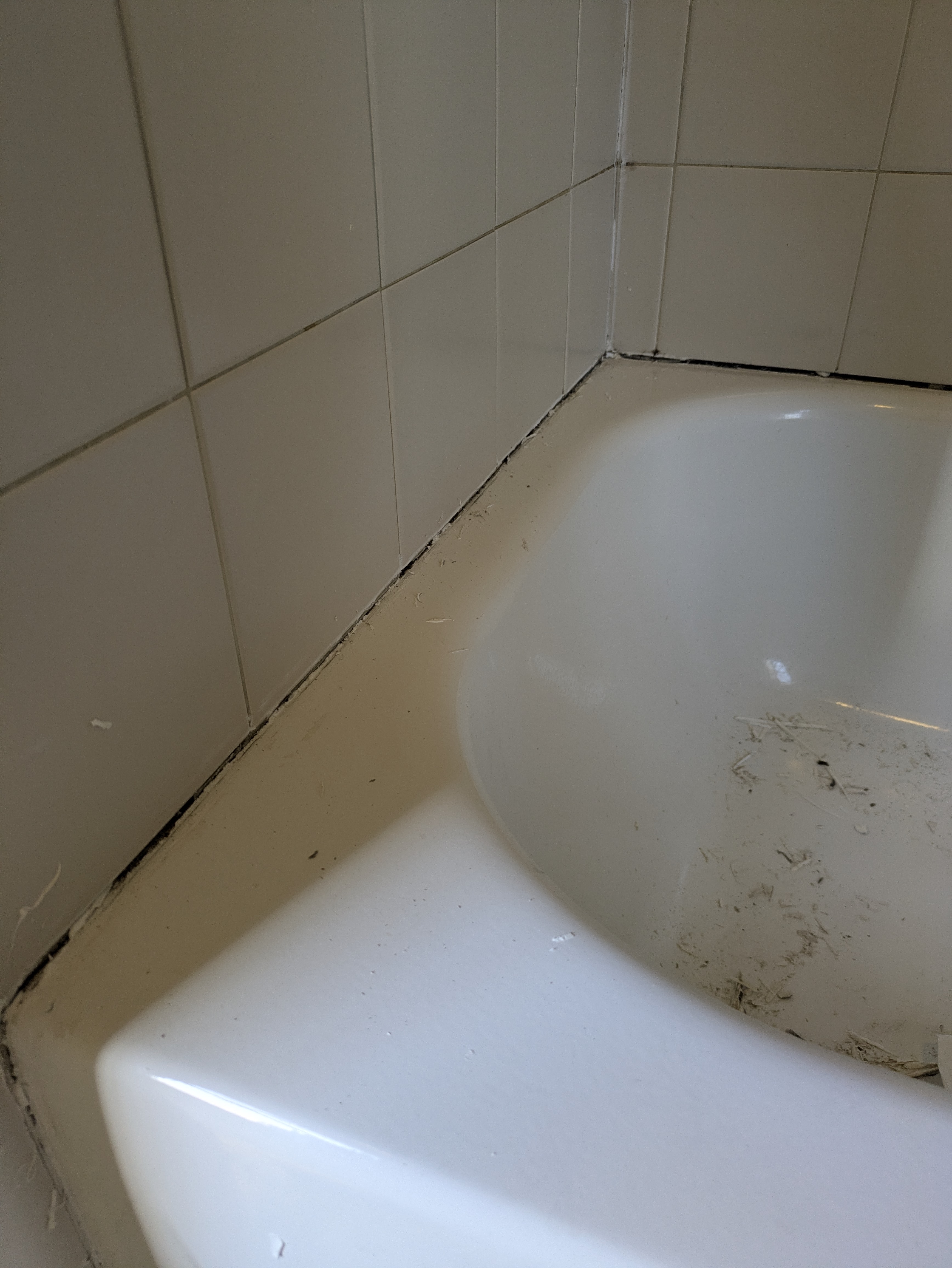 Clean white bathtub surround in a renovated Athens bathroom